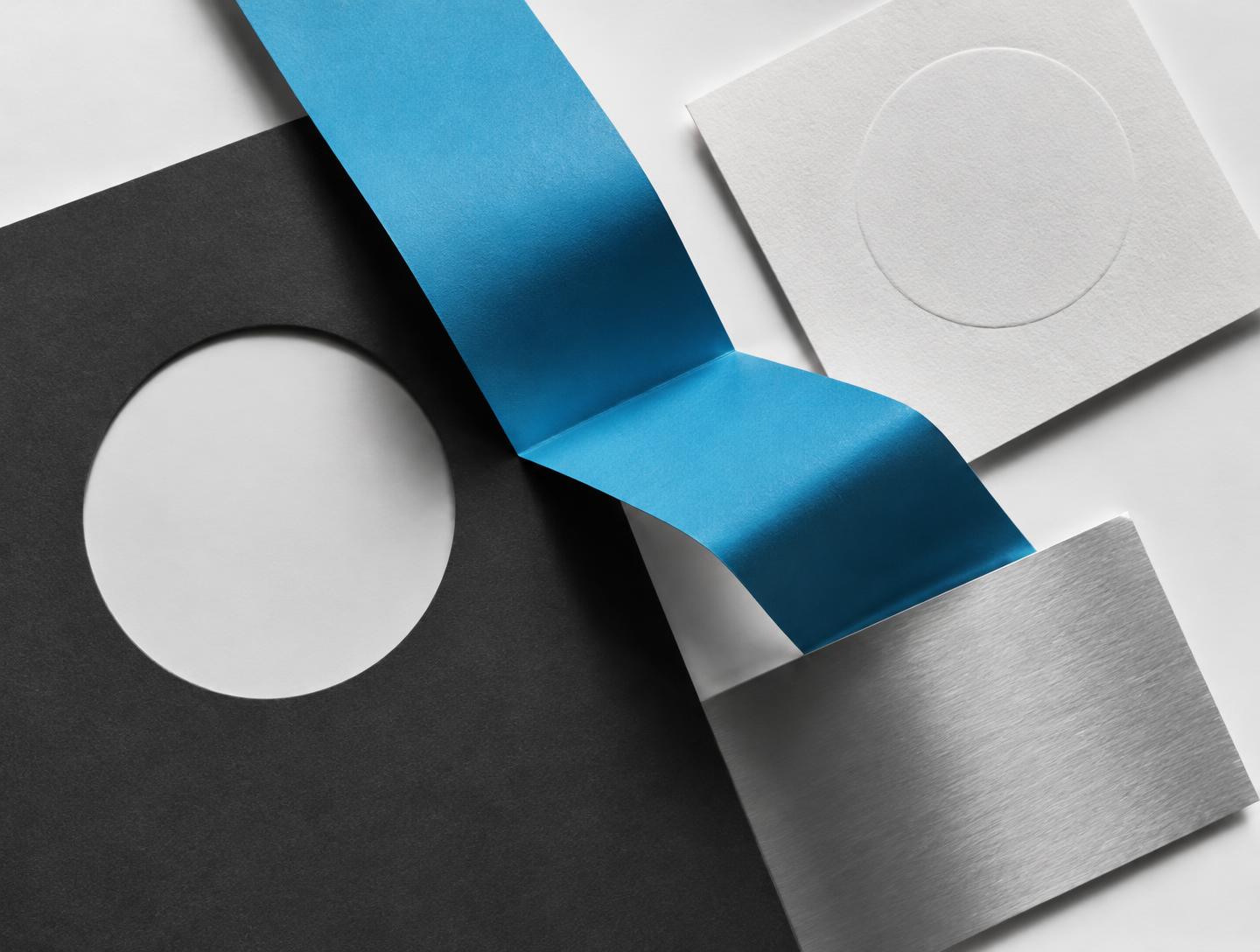 Original graphic study in folded blue paper, charcoal and embossed white shapes